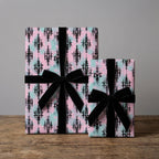 Luxury gothic damask wrapping paper in pink and mint with black velvet ribbons by Wrapped Studios.