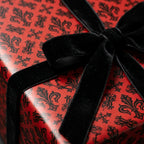 Luxury red and black fleur-de-lis wrapping paper with velvet bow by Wrapped Studios.