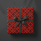 Luxury gothic wrapping paper with red and black fleur-de-lis pattern and black bow by Wrapped Studios.