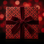 Luxury red and black fleur-de-lis Christmas wrapping paper with a velvet bow by Wrapped Studios.