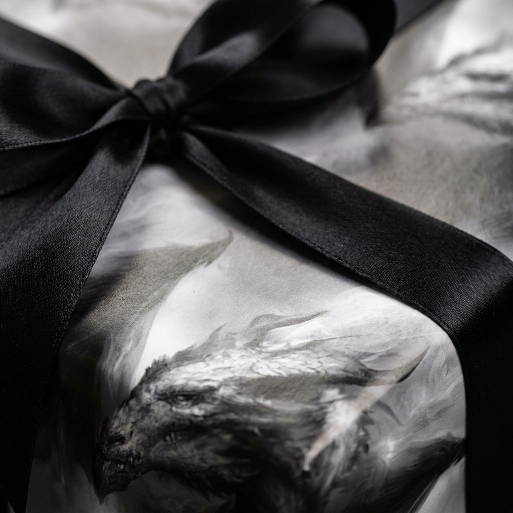 Gothic dragon wrapping paper with black satin bow, luxury fantasy gift wrap by Wrapped Studios.