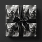 Dark fantasy dragon wrapping paper in black and grey with a black bow by Wrapped Studios.
