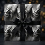 Dark fantasy dragon wrapping paper by Wrapped Studios on a gift box with a black ribbon bow.