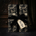 Elegant black & cream floral bird wrapping paper, velvet ribbon, 'For You' tag. Wrapped Studios.