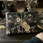 Gothic Grandeur wrapping paper: dark floral & bird pattern, white flowers, jute twine bow. Elegant luxury gift wrap.