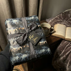 Gothic wrapping paper, vintage style Halloween gift wrap tied with grey ribbon and a "For You" gift tag.