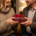 Couple exchanging gift in romantic red heart wrapping paper with velvet bow, by Wrapped Studios.