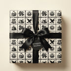 Gothic skull wrapping paper with a black satin bow on a square gift box, by Wrapped Studios.