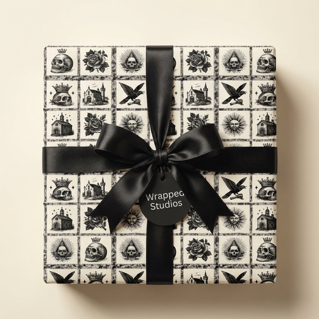 Gothic skull wrapping paper with a black satin bow on a square gift box, by Wrapped Studios.