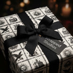 Gothic skull wrapping paper by Wrapped Studios, featuring a vintage black and white pattern and a black bow.