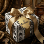 Gothic wrapping paper with vintage skull pattern and luxury gold bow by Wrapped Studios.