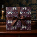 Luxury gift box with a moth & crescent moon pattern gift wrap and brown satin ribbon.