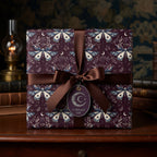 Luxury gift box with a moth & crescent moon pattern gift wrap and brown satin ribbon.