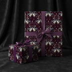 Elegant moth and moon wrapping paper on gifts tied with purple satin ribbon.