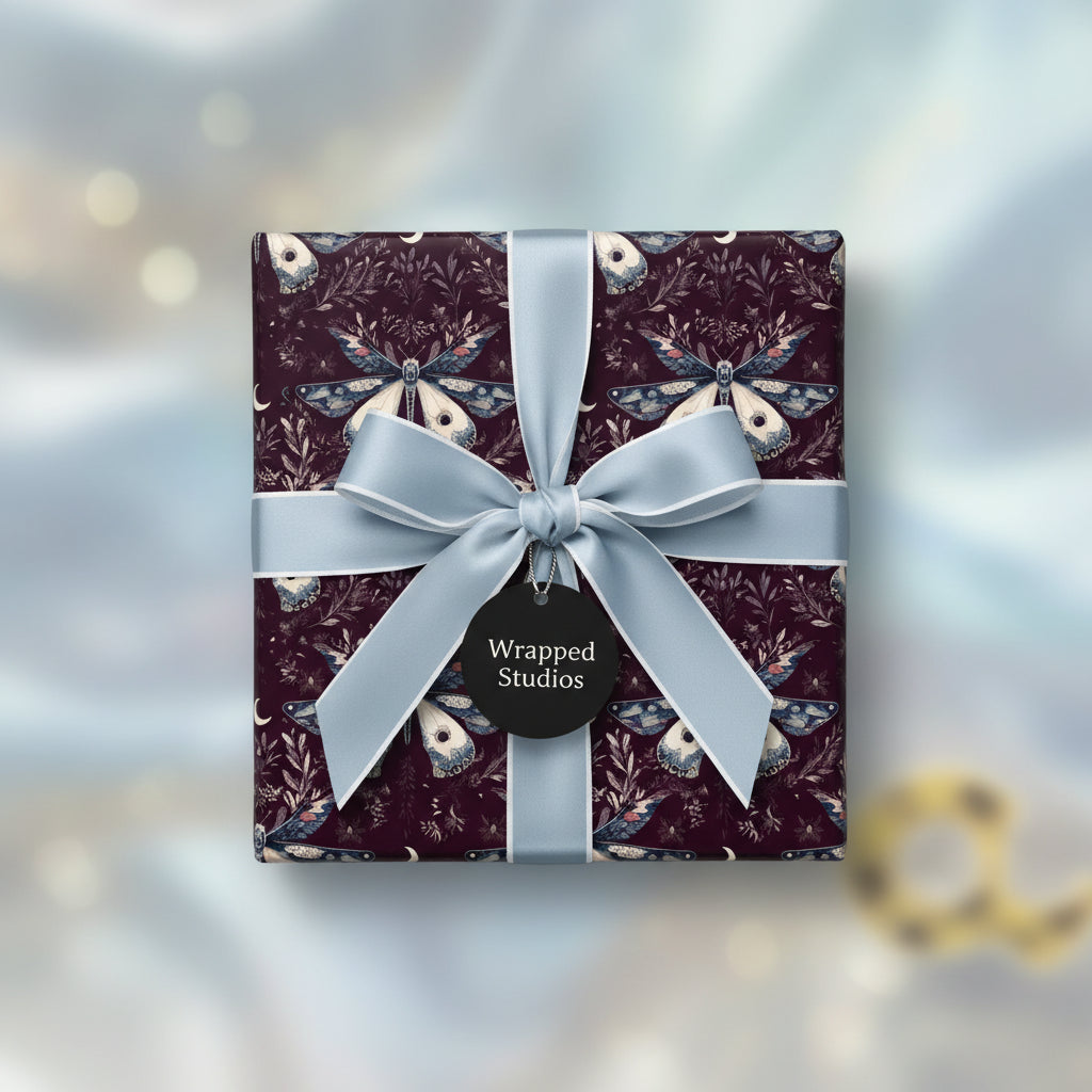 Burgundy gift box with a moth pattern wrapping paper and powder blue satin ribbon.