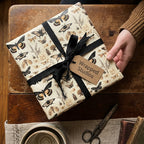 Wrapped Studios gift wrapped in vintage butterfly patterned paper with a black ribbon.