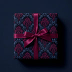 Elegant square gift box with luxury floral wrapping paper and wine-colored satin ribbon.