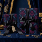 Luxury gift wrap with a dark floral damask pattern and black satin ribbon.
