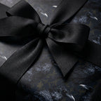 Gothic raven wrapping paper with a black grosgrain ribbon bow by Wrapped Studios.