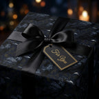 Gothic raven wrapping paper with a luxury black satin bow and gift tag by Wrapped Studios.