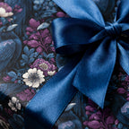 Luxury dark floral wrapping paper by Wrapped Studios, featuring a blue satin bow over a crow and purple flower print.