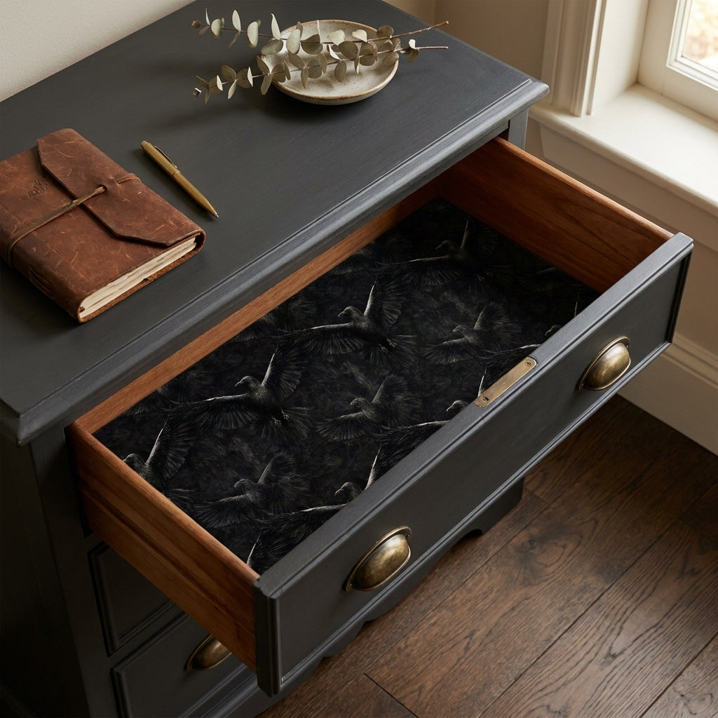 Dark academia gothic raven wrapping paper with flying black crows in a drawer, by Wrapped Studios.
