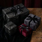 Gothic raven wrapping paper and luxury dark gift wrap with satin bows by Wrapped Studios.