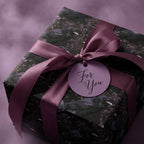 Gothic crow and dark floral wrapping paper with a purple satin bow by Wrapped Studios.