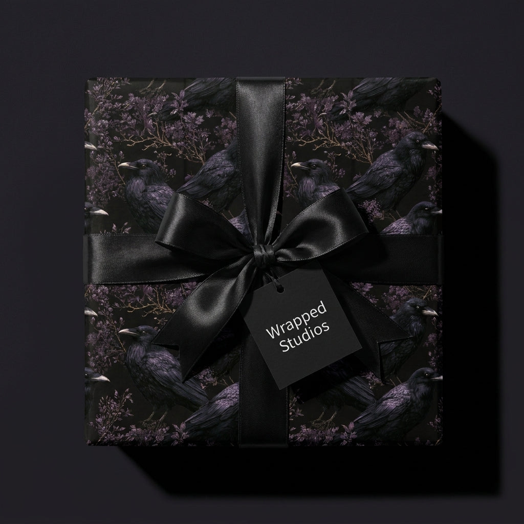 Gothic crow wrapping paper with a black satin bow on a luxury gift box by Wrapped Studios.