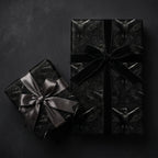 Dark raven gothic wrapping paper on gifts with elegant black velvet and satin bows by Wrapped Studios.