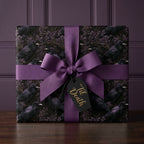 Gothic wedding wrapping paper with ravens, purple bow, and 'Til Death tag by Wrapped Studios.