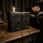 Gothic raven wrapping paper by Wrapped Studios on a luxury gift box tied with black twine.