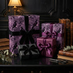 Elegant gift wrap featuring raven and floral patterns in shades of purple, with velvet and satin ribbons, for a luxurious present.