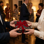 Luxury floral wrapping paper with a red velvet bow gifted at a holiday party by Wrapped Studios.