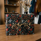 Moody vintage floral wrapping paper on a gift box with gold string by Wrapped Studios.