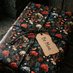 Moody dark floral Valentine's Day wrapping paper with a Be Mine gift tag by Wrapped Studios.