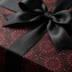 Luxury burgundy and black gothic wrapping paper with a satin ribbon bow by Wrapped Studios.