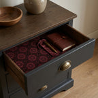 Luxury burgundy drawer liner paper with vintage floral pattern in a wooden drawer. Wrapped Studios.