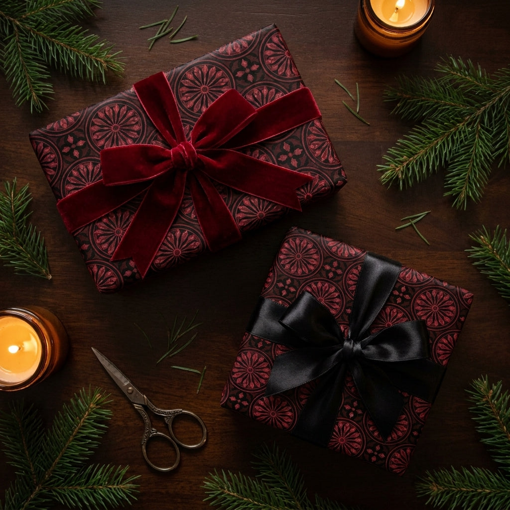 Luxury burgundy gothic Christmas wrapping paper with red velvet and black satin bows by Wrapped Studios.