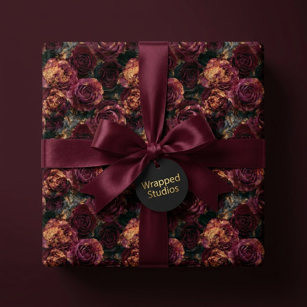 Luxury burgundy floral wrapping paper with gold roses and satin bow, by Wrapped Studios.