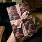 Luxury vintage floral wrapping paper with burgundy roses and a pink ribbon by Wrapped Studios.