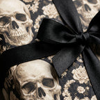 Gothic skull wrapping paper with a black satin bow, luxury Halloween gift wrap by Wrapped Studios.