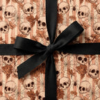 Gothic skull Halloween wrapping paper with a black ribbon bow by Wrapped Studios.