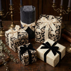 Gothic skull wrapping paper with velvet bows for luxury Halloween gift wrapping by Wrapped Studios.