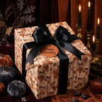 Gothic skull Halloween wrapping paper with a luxury black satin bow by Wrapped Studios.