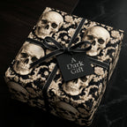 Gothic skull gift wrap with elegant baroque patterns and a black ribbon bow by Wrapped Studios.
