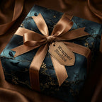 Elegant gift wrapped in navy floral wrapping paper with gold ribbon, from Wrapped Studios.