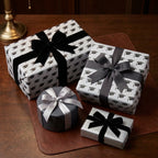 Graduation wrapping paper with a black mortarboard pattern and elegant bows by Wrapped Studios.