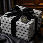 Graduation wrapping paper with black mortarboards and luxury velvet bow by Wrapped Studios.