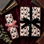 Pink graduation cat wrapping paper with velvet ribbons on gifts by Wrapped Studios.